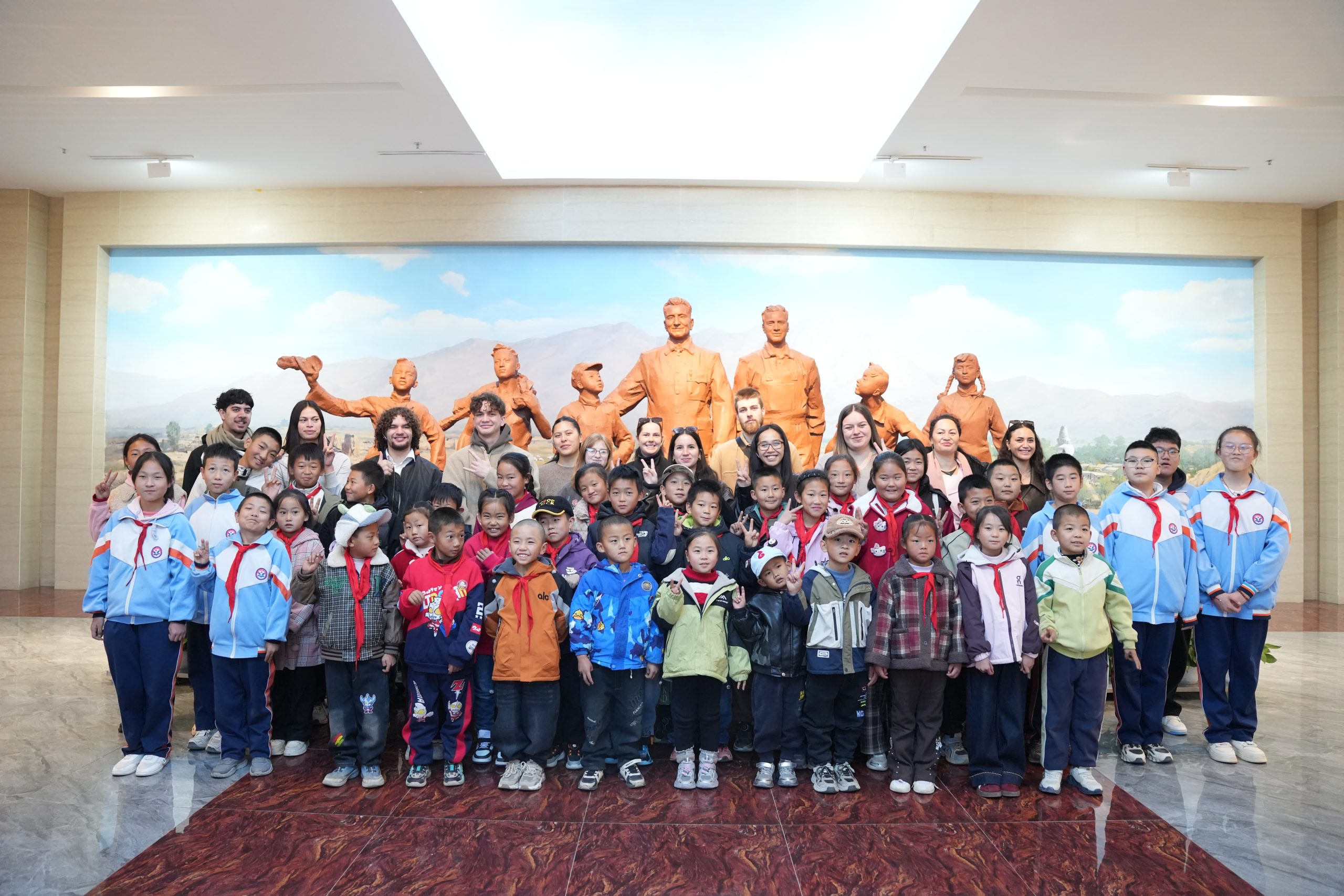 An Eastern Bridge volunteer teaching English to a class of young primary school students in China.