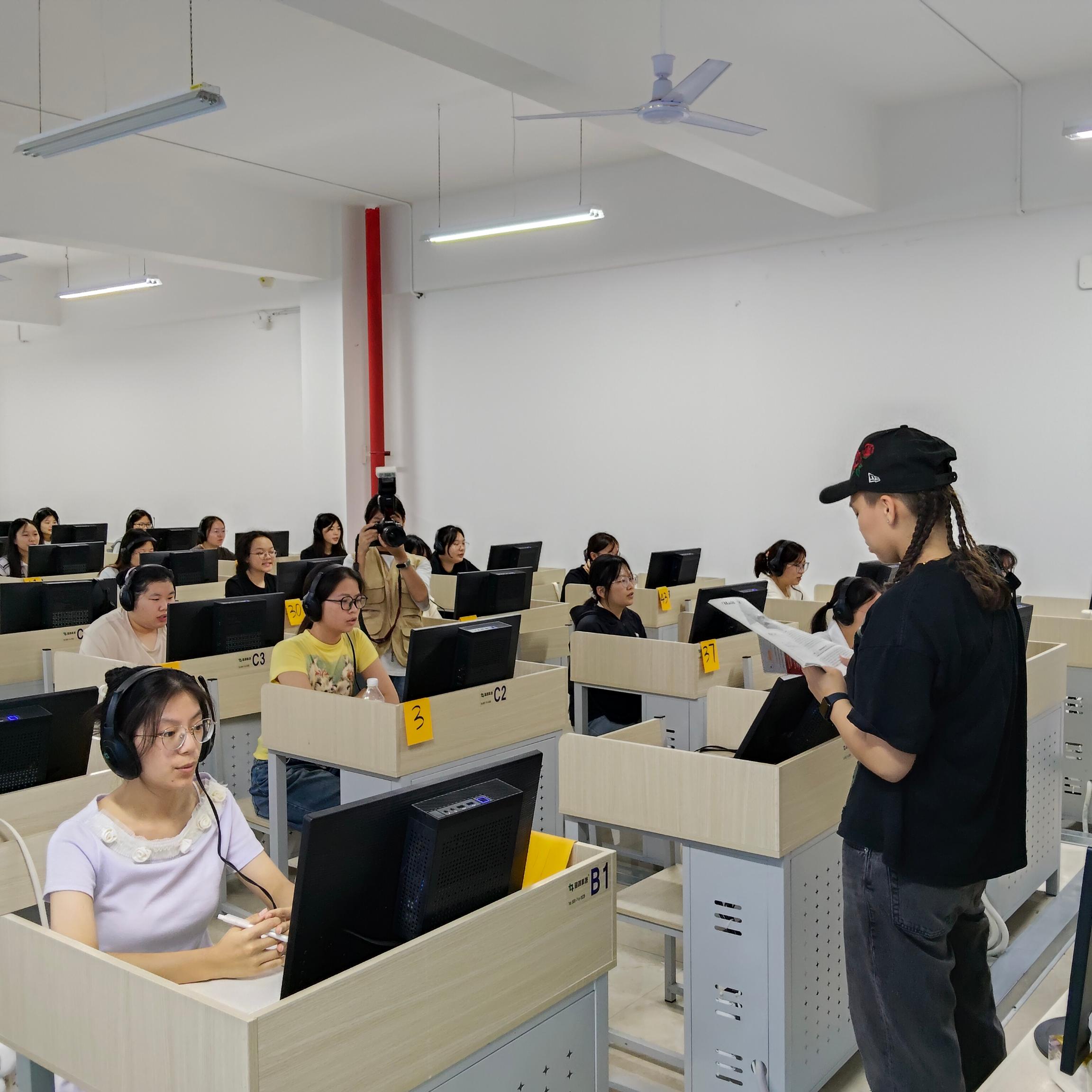 Chinese students practising English listening with a New Zealand exchange student