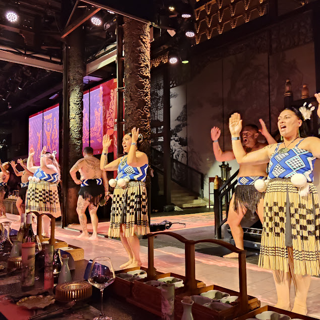 Māori performers in traditional dress performing on stage in China